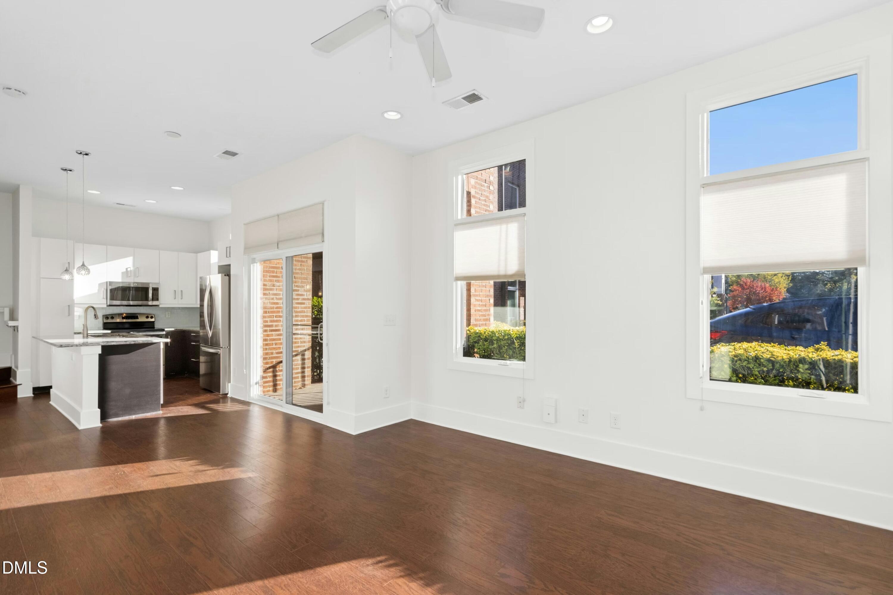 226 William Drummond Way Raleigh, NC 27604 - Photo 11 of 34 a view of a kitchen with furniture a ceiling fan and wooden floor
