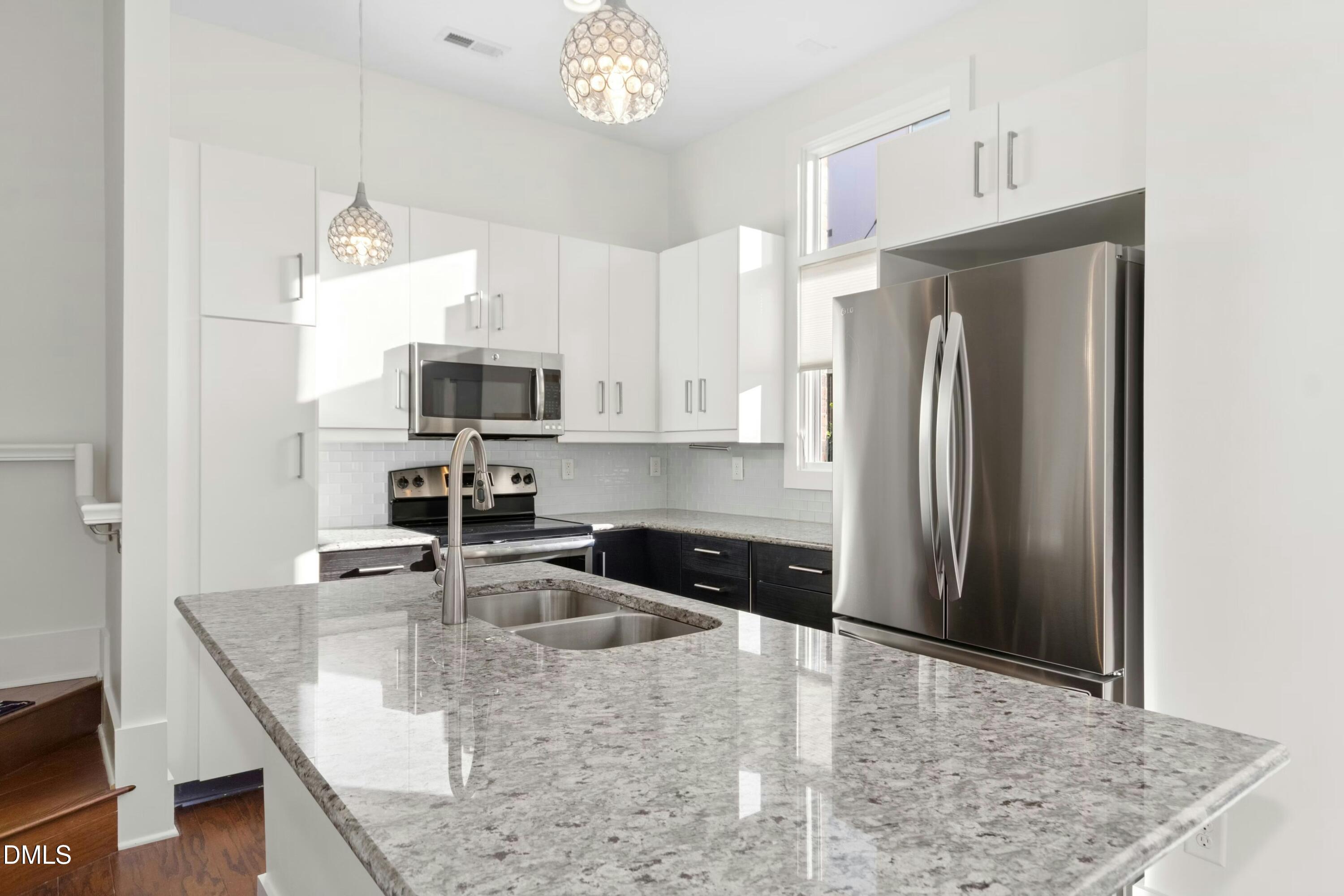 226 William Drummond Way Raleigh, NC 27604 - Photo 13 of 34 a kitchen with stainless steel appliances granite countertop a sink refrigerator and microwave