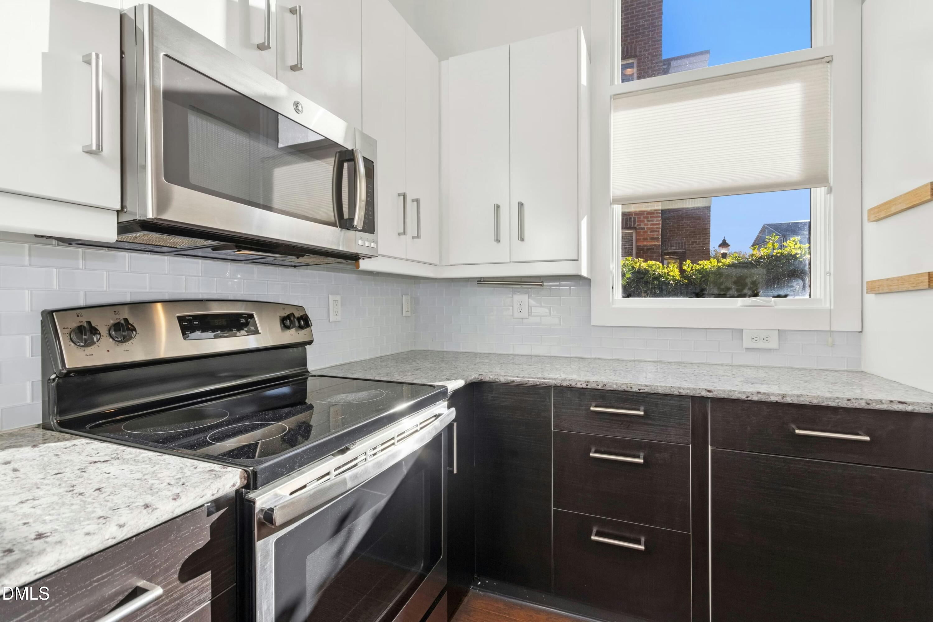 226 William Drummond Way Raleigh, NC 27604 - Photo 15 of 34 a kitchen with stainless steel appliances granite countertop a stove and a microwave