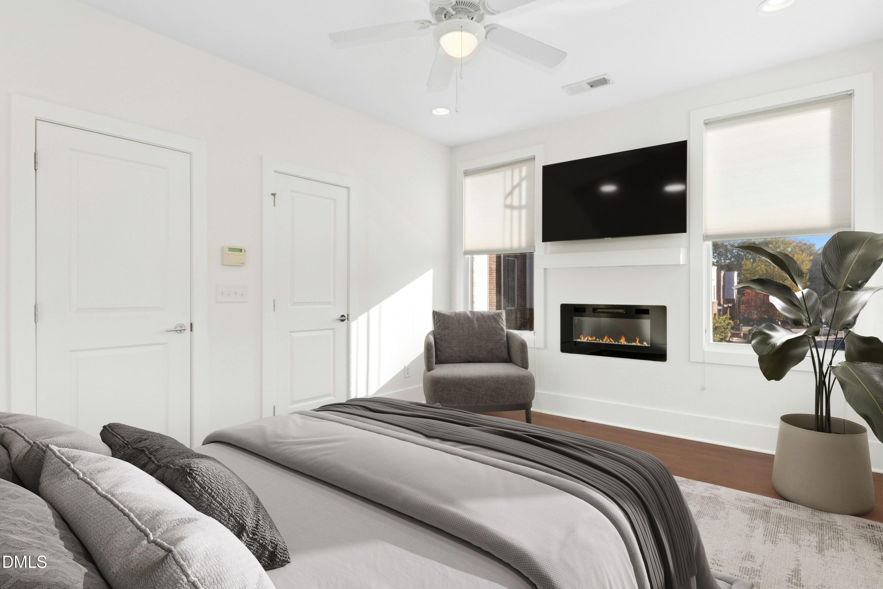 226 William Drummond Way Raleigh, NC 27604 - Photo 17 of 34 a spacious bedroom with a bed and a fireplace