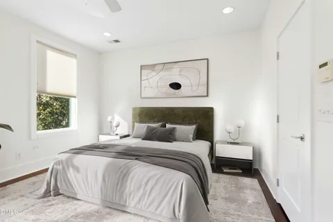 an empty room with windows and fireplace