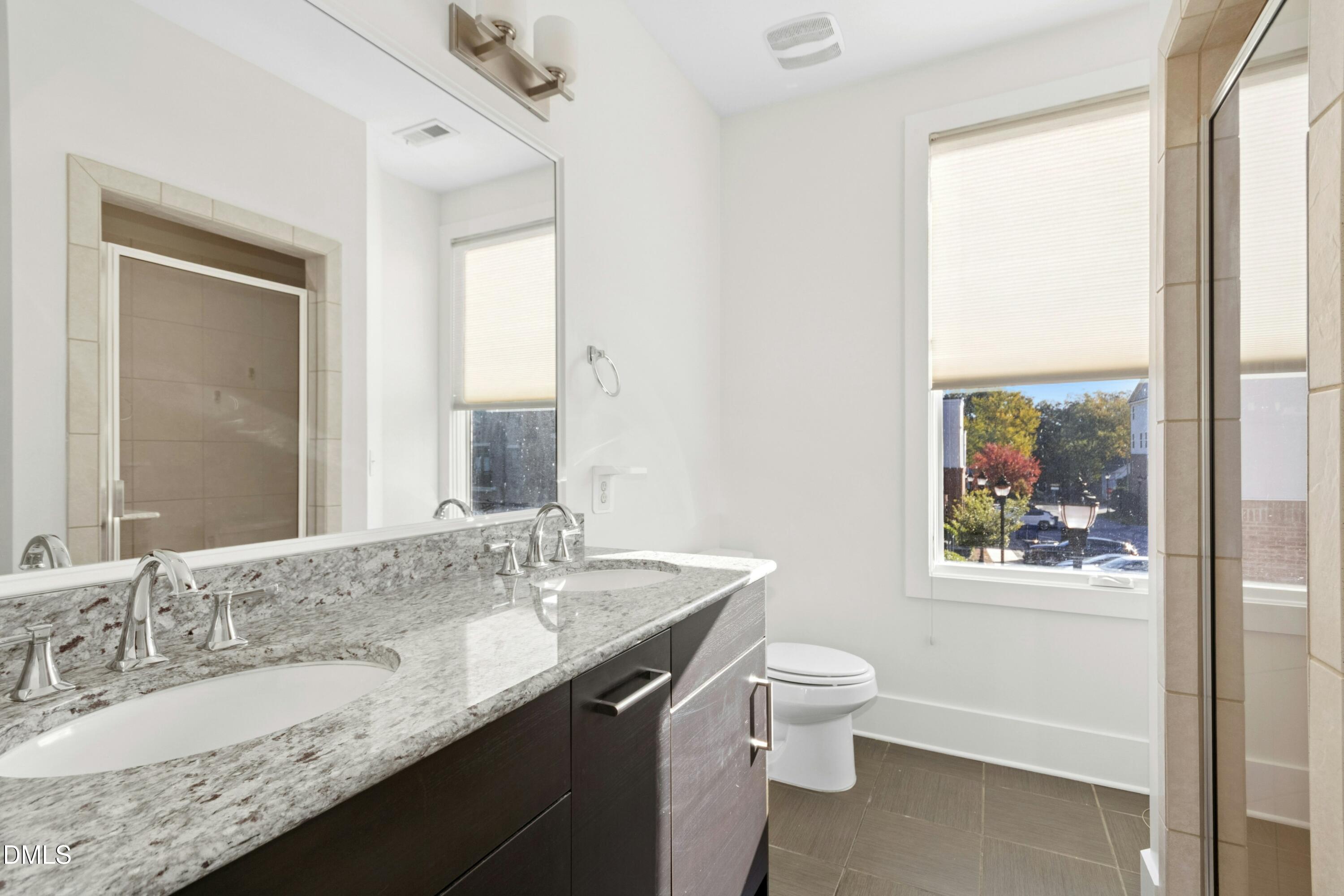 226 William Drummond Way Raleigh, NC 27604 - Photo 23 of 34 a bathroom with a granite countertop sink toilet and large mirror