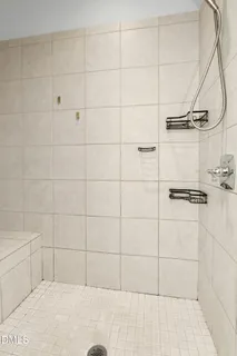 a bathroom with a granite countertop sink toilet and large mirror