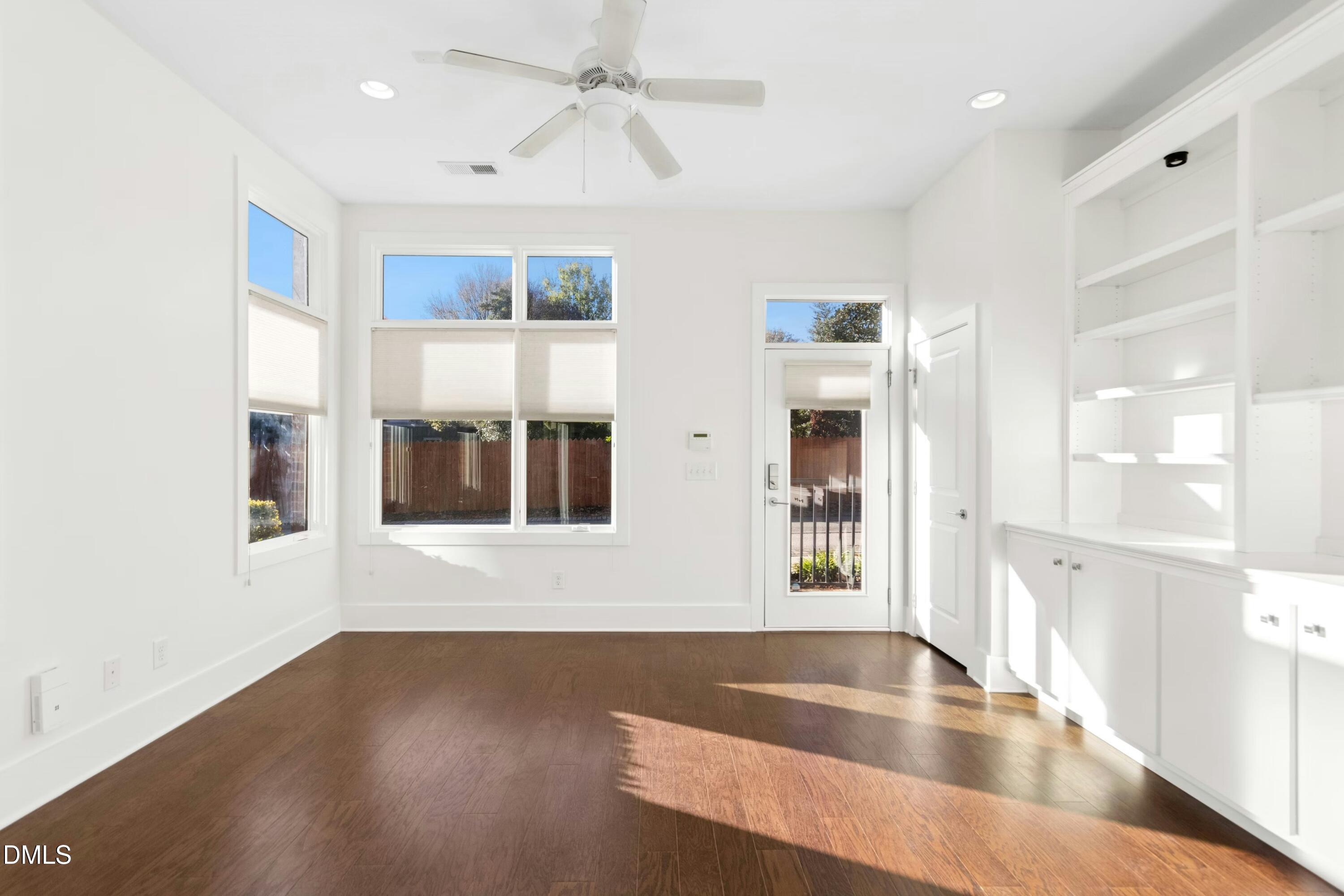 226 William Drummond Way Raleigh, NC 27604 - Photo 8 of 34 a view of an empty room with window and wooden floor