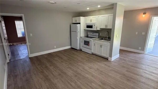 a kitchen with stainless steel appliances a refrigerator and a stove top oven
