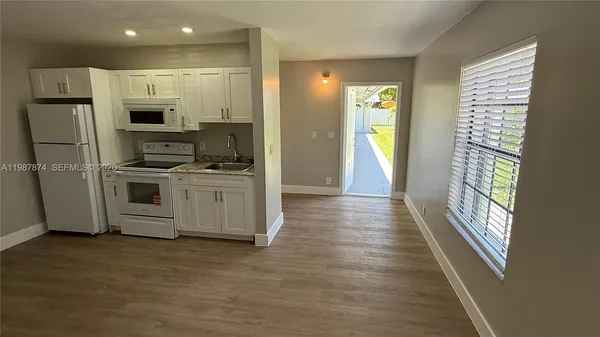 a kitchen with stainless steel appliances a refrigerator and a stove top oven