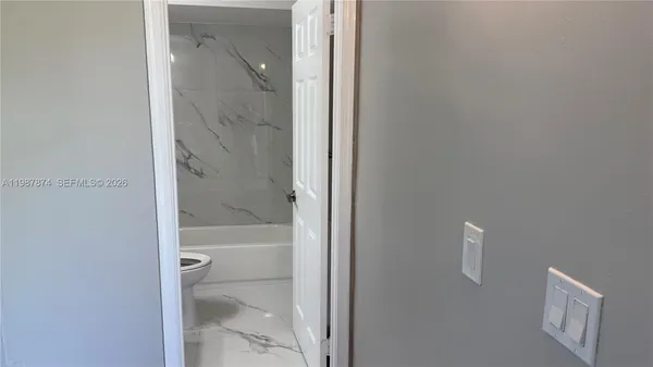 a bathroom with a glass shower door