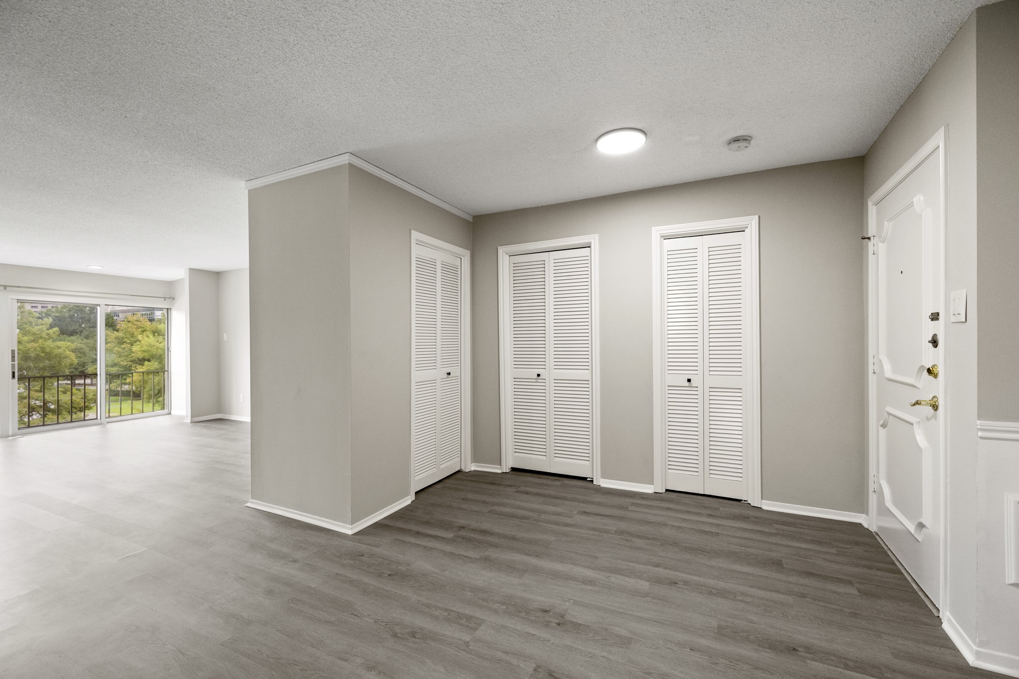 5050 Ambassador Way, Unit 316 Houston, TX 77056 - Photo 11 of 11 a view of an empty room with wooden floor and a window