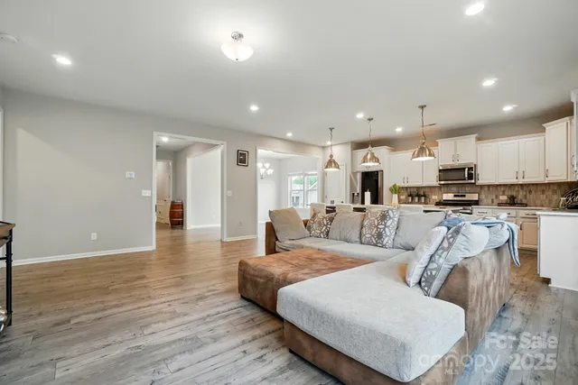 a living room with furniture and kitchen view