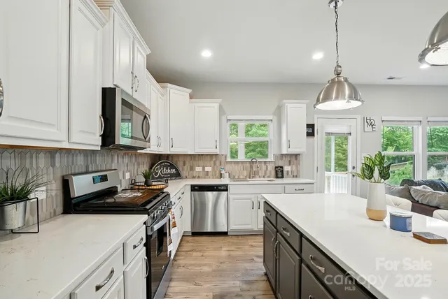a kitchen with a sink stove top oven and microwave