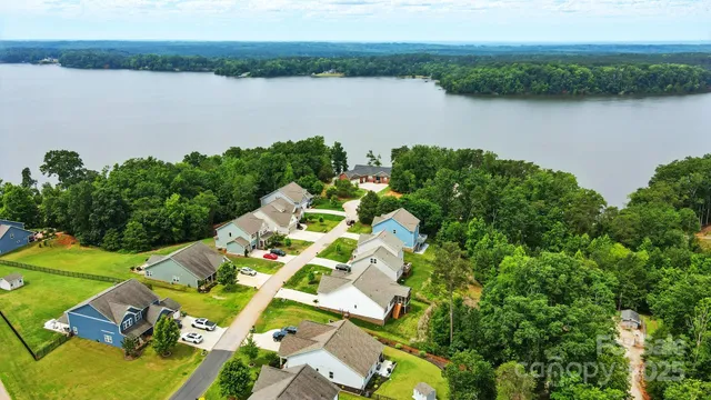 an aerial view of lake and residential houses with outdoor space