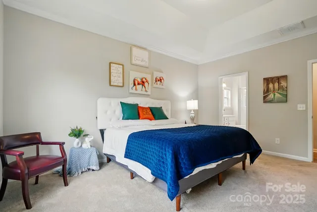 a bedroom with a bed and a chair