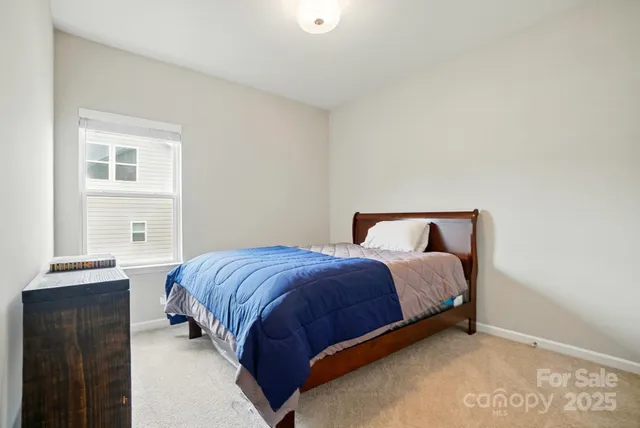 a bedroom with a bed and with furniture