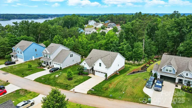 an aerial view of a house with garden space and street view