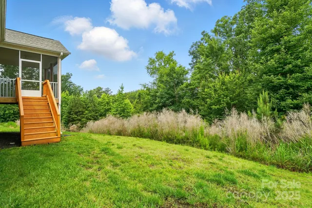 a view of a backyard with plants and a lake view