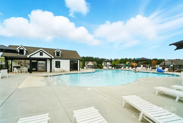 a view of a swimming pool with a lounge chair