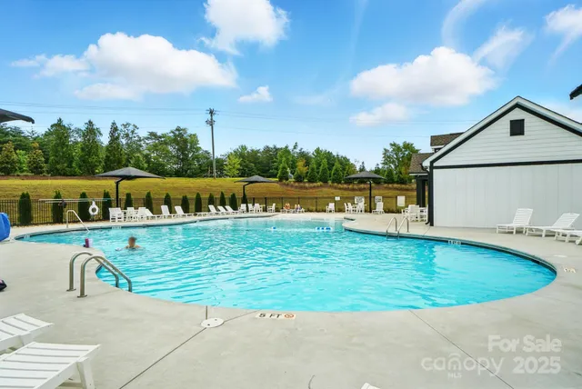 an aerial view of a house with swimming pool patio and outdoor seating