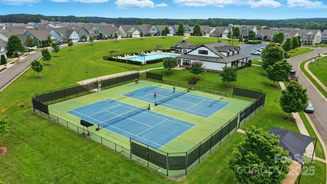 an aerial view of a house with yard swimming pool and outdoor seating