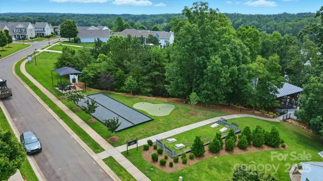 an aerial view of a house with swimming pool outdoor seating and yard