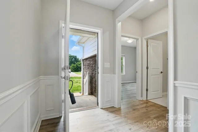 a view of entryway with wooden floor and door