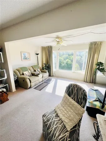 a bedroom with furniture and a large window
