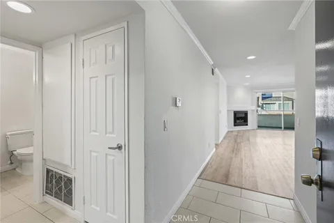 a view of empty room with wooden floor and fireplace