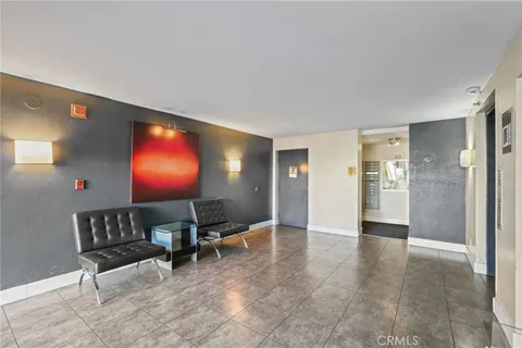 a view of a patio with table and chairs and potted plants with wooden floor and fence