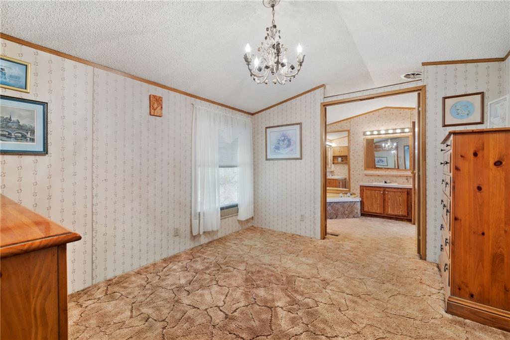 385 Garner Road Edinburg, PA 16116 - Photo 12 of 31 a view of a hallway with a chandelier and closet