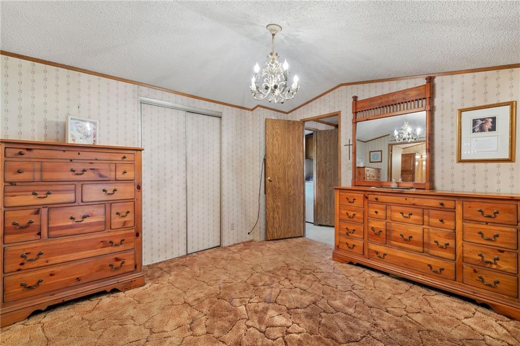 385 Garner Road Edinburg, PA 16116 - Photo 18 of 31 walk in closet with a mirror and a dresser