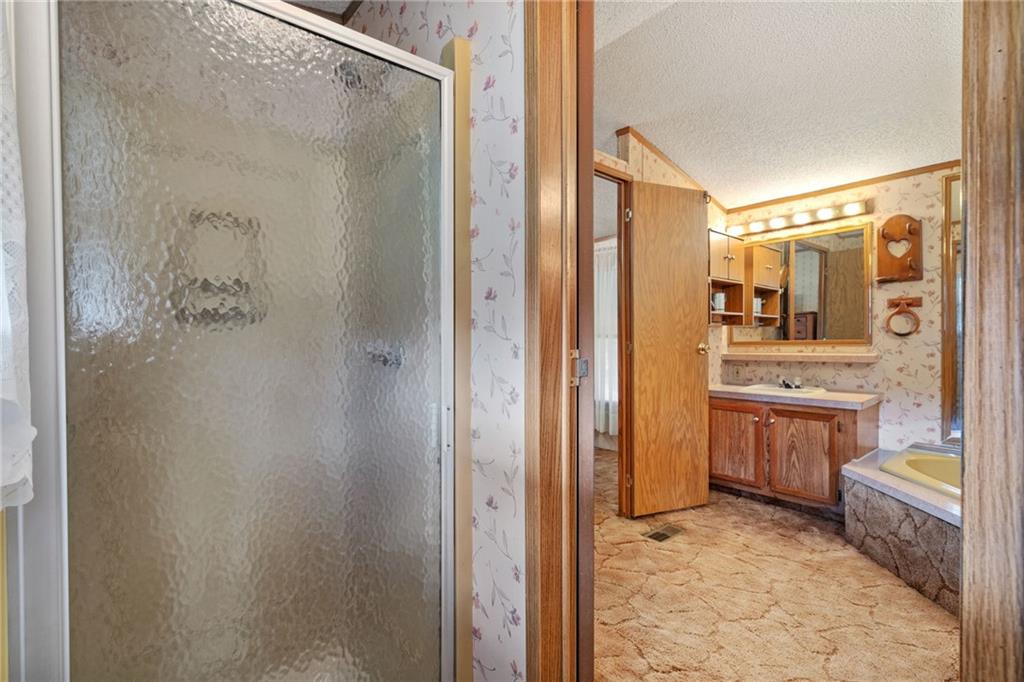 385 Garner Road Edinburg, PA 16116 - Photo 21 of 31 a bathroom with a granite countertop sink mirror and shower