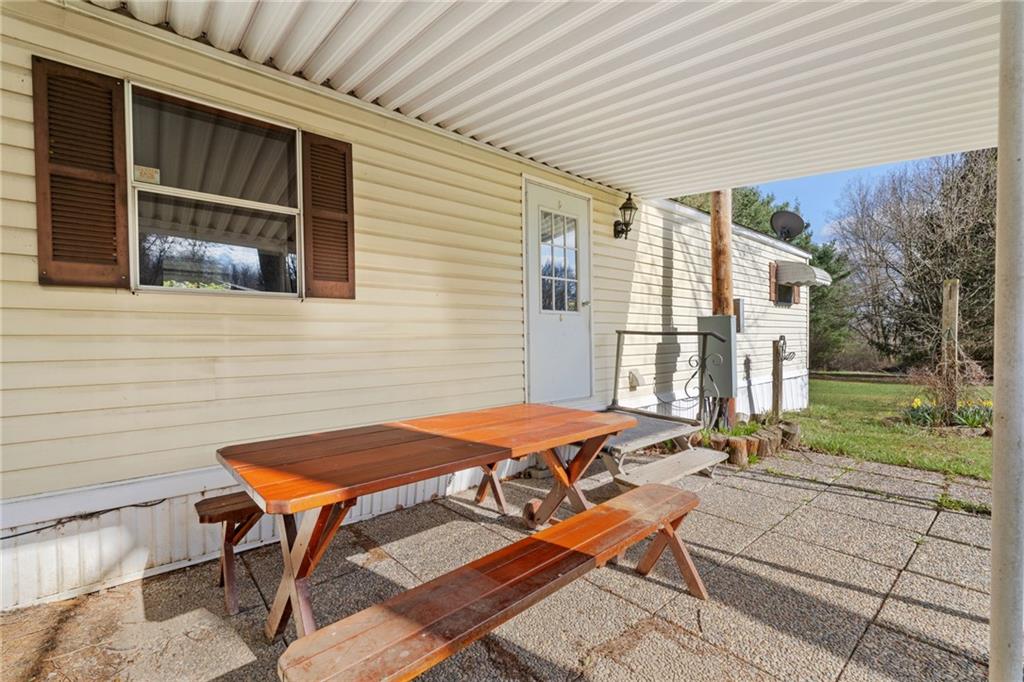 385 Garner Road Edinburg, PA 16116 - Photo 3 of 31 a backyard of a house with table and chairs