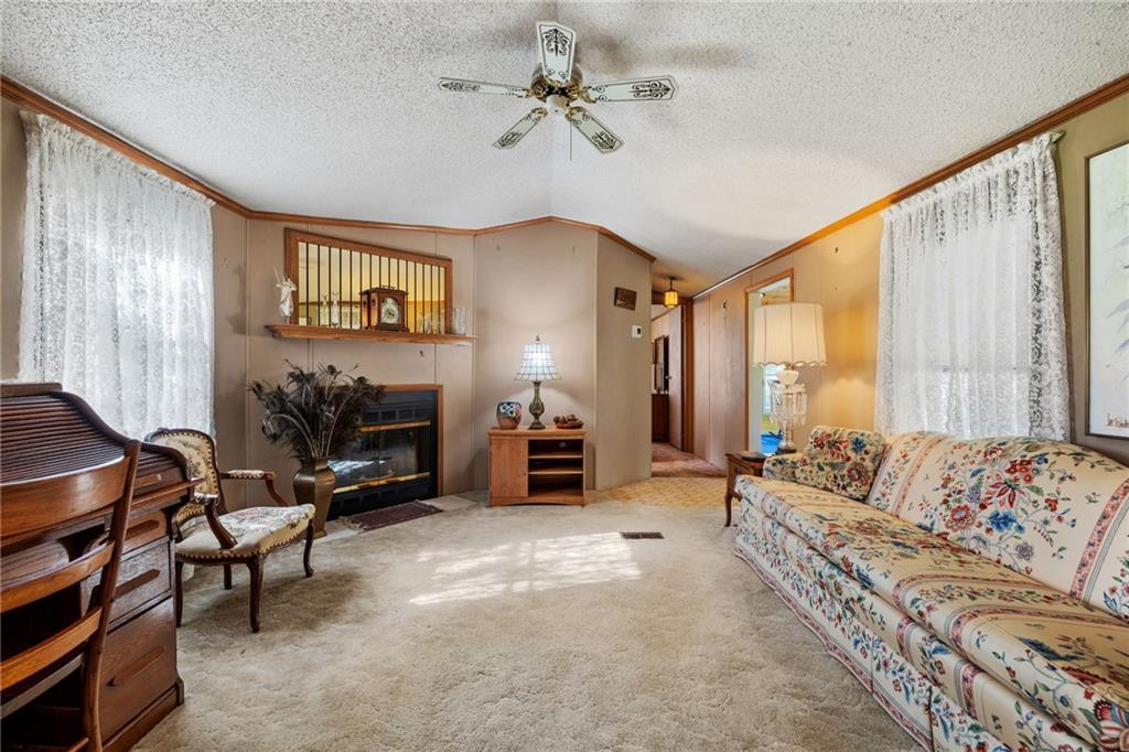 385 Garner Road Edinburg, PA 16116 - Photo 8 of 31 a living room with furniture and a fireplace