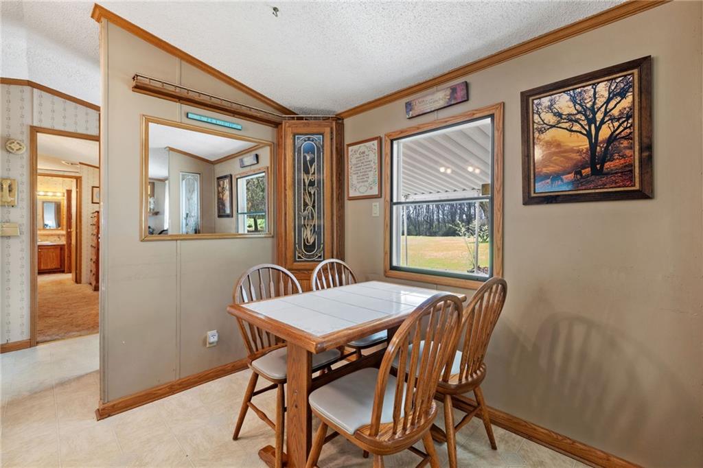 385 Garner Road Edinburg, PA 16116 - Photo 9 of 31 a view of a dining room with furniture a livingroom and wooden floor