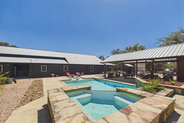 an outdoor view of the house and swimming pool