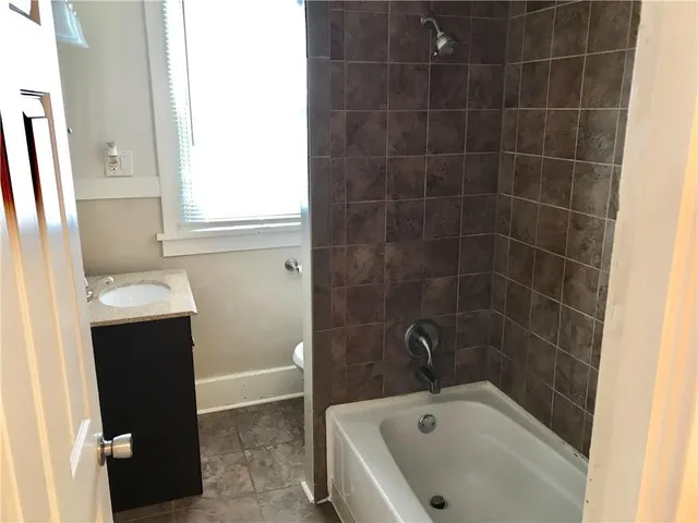 a kitchen with stainless steel appliances granite countertop a sink and cabinets with wooden floor