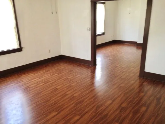 a view of a hallway with wooden floor
