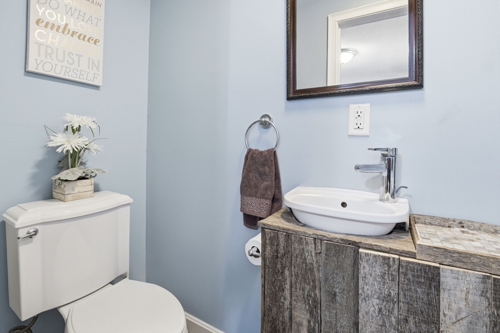 153 Summer Street Maynard, MA 01754 - Photo 13 of 26 a bathroom with a toilet a sink and mirror