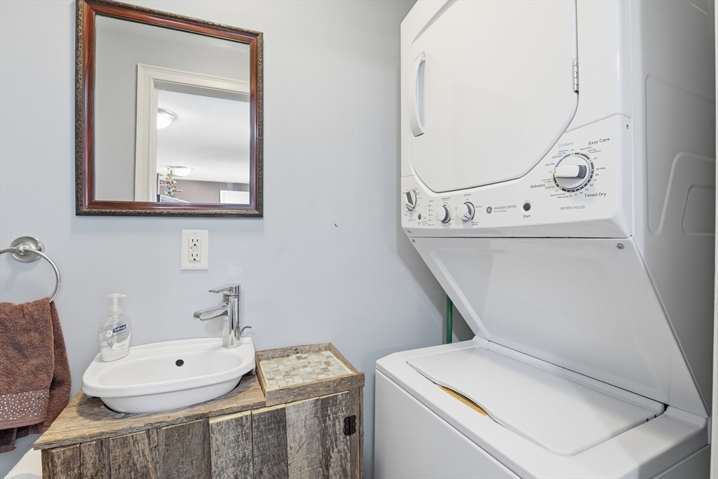 153 Summer Street Maynard, MA 01754 - Photo 14 of 26 a bathroom with a toilet a sink and mirror