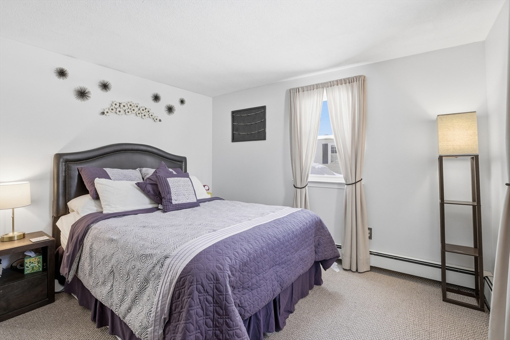 153 Summer Street Maynard, MA 01754 - Photo 16 of 26 a bedroom with a bed and a lamp