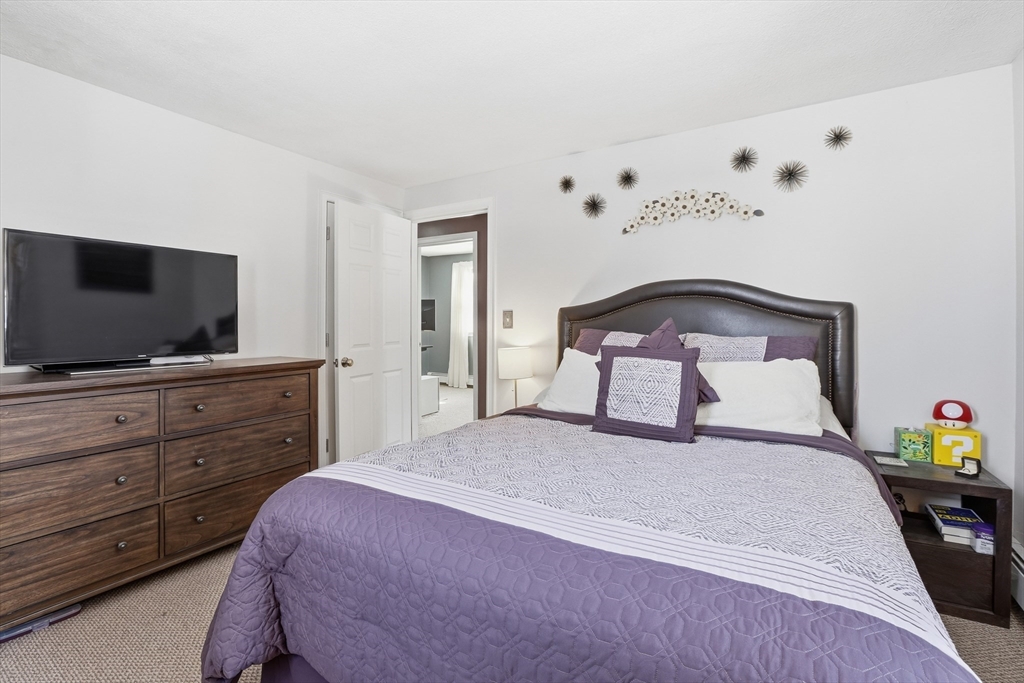 153 Summer Street Maynard, MA 01754 - Photo 17 of 26 a bedroom with a bed and flat screen tv
