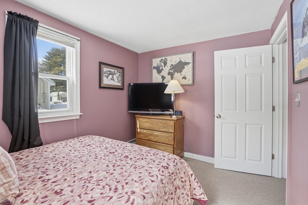 153 Summer Street Maynard, MA 01754 - Photo 20 of 26 a bedroom with a bed and a television