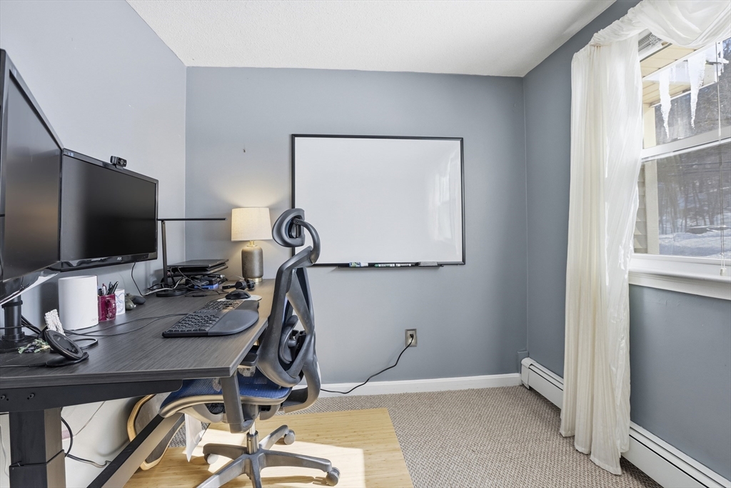 153 Summer Street Maynard, MA 01754 - Photo 22 of 26 a room with gym equipment and a flat screen tv