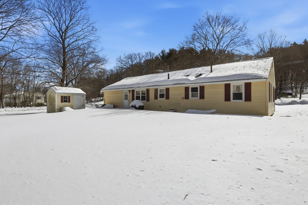 153 Summer Street Maynard, MA 01754 - Photo 25 of 26 a front view of house with yard and trees in the background