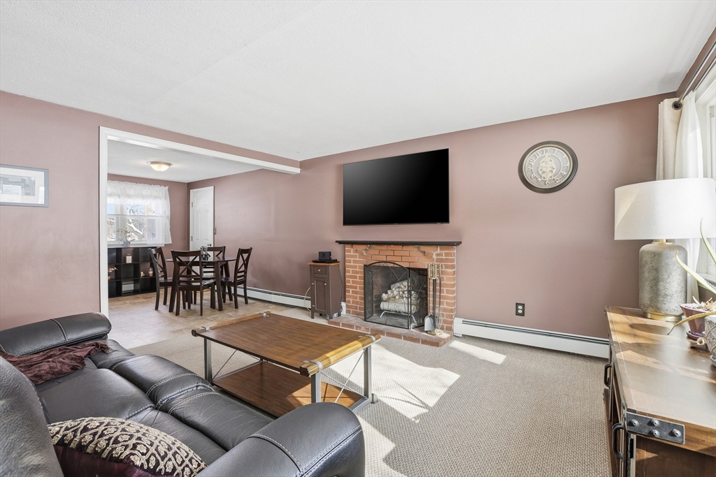 153 Summer Street Maynard, MA 01754 - Photo 3 of 26 a living room with furniture a fireplace and a flat screen tv