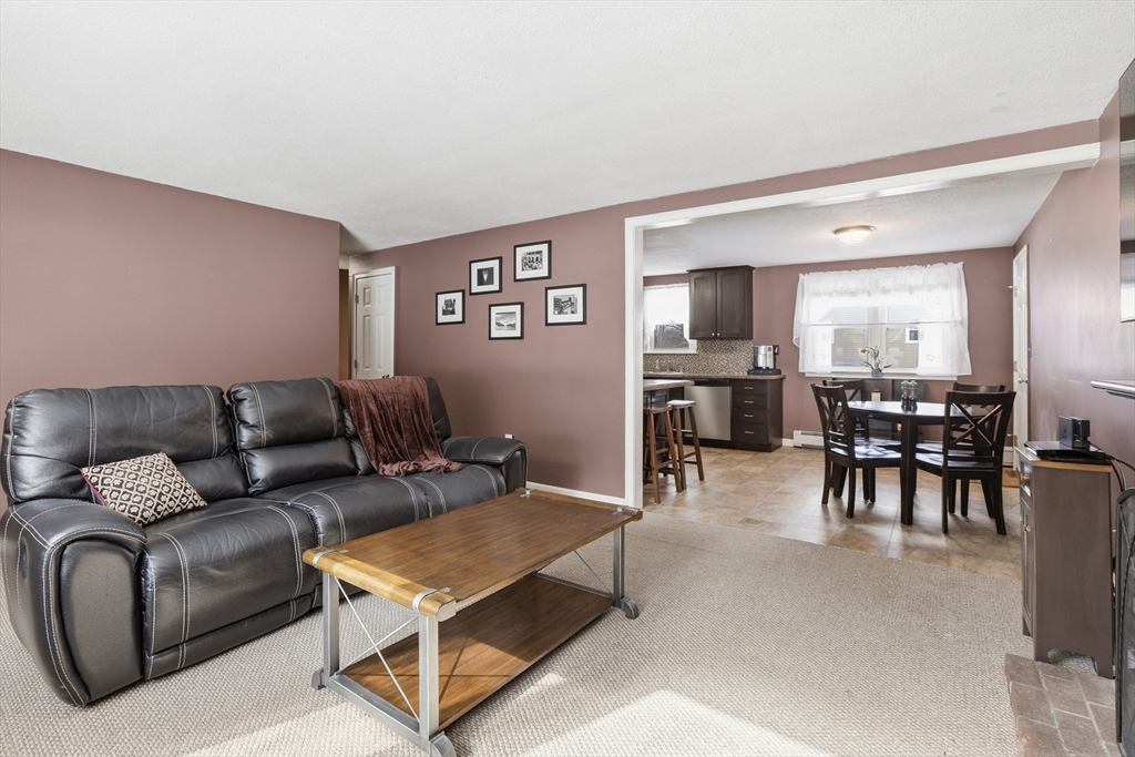 153 Summer Street Maynard, MA 01754 - Photo 6 of 26 a living room with furniture a dining table and kitchen view