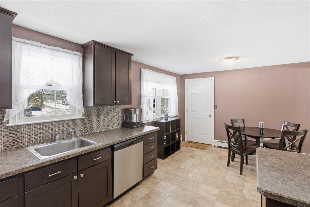 153 Summer Street Maynard, MA 01754 - Photo 10 of 26 a kitchen with a sink and chairs