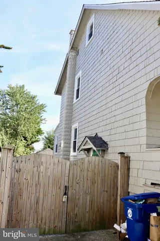a view of a house with wooden fence