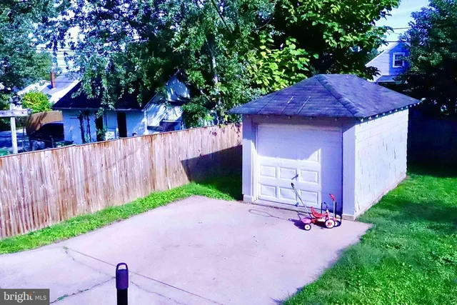 a view of a house with a yard and tree