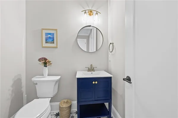 a bathroom with a toilet a sink and mirror