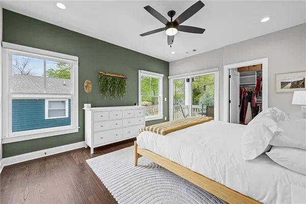 a bedroom with a large bed and a window